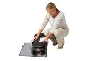 a woman packing a Graco playard